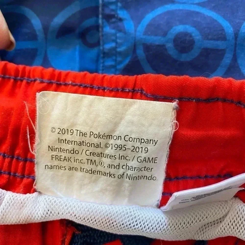Boys Pokémon branded swim trunks.‎ Size M